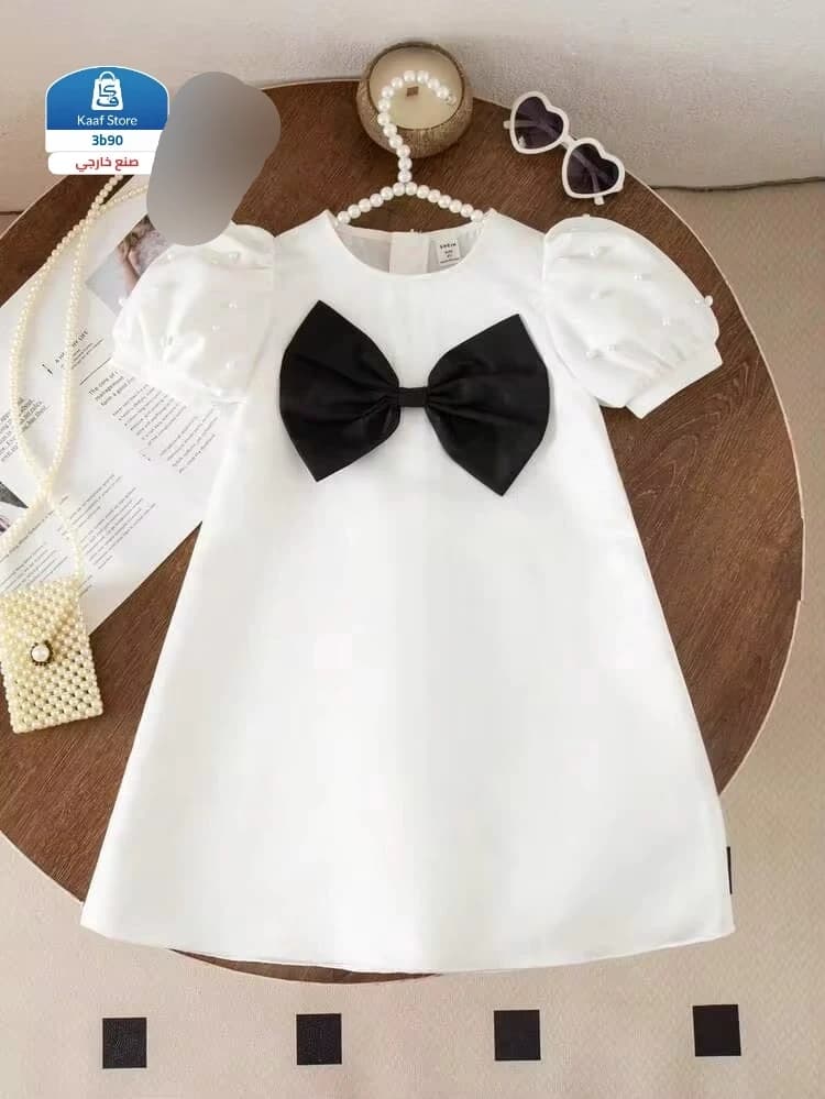 فستان بناتي أبيض أنيق مزين بفيونكة سوداء thumbnail 2